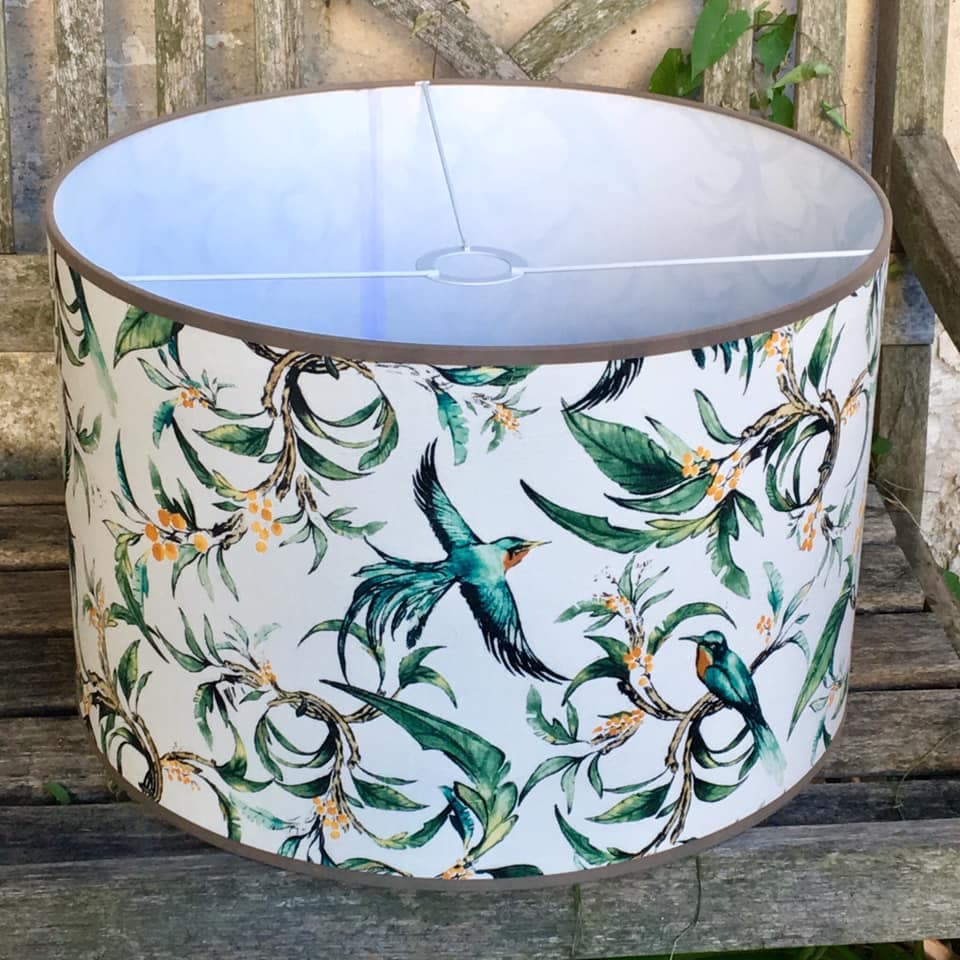 Fabric featuring blue exotic birds against a green foliage background, view 2