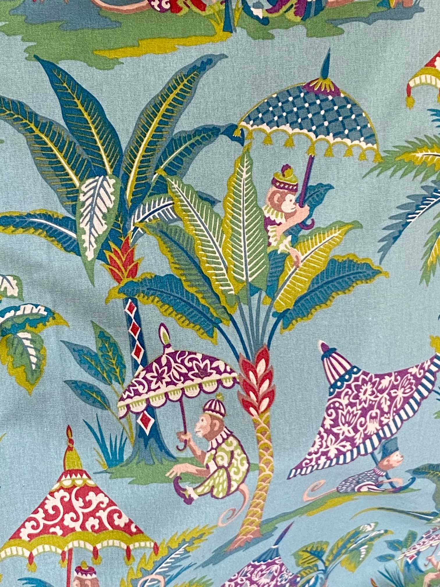 Fabric featuring monkeys and a parasol on a blue background, view 2