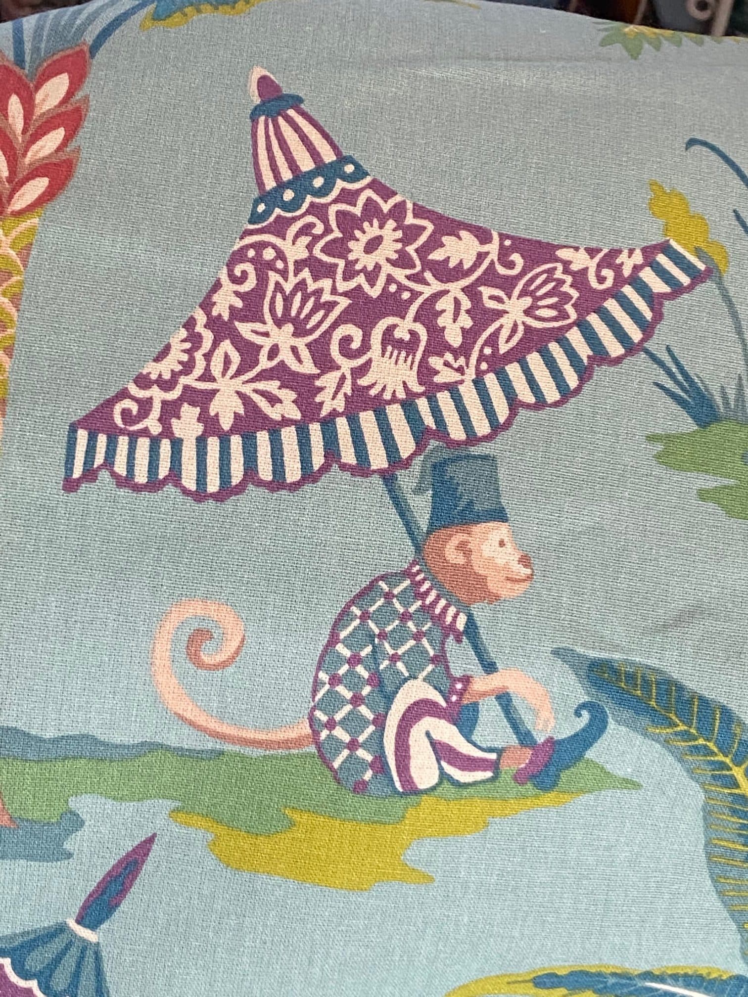 Fabric featuring monkeys and a parasol on a blue background, view 3