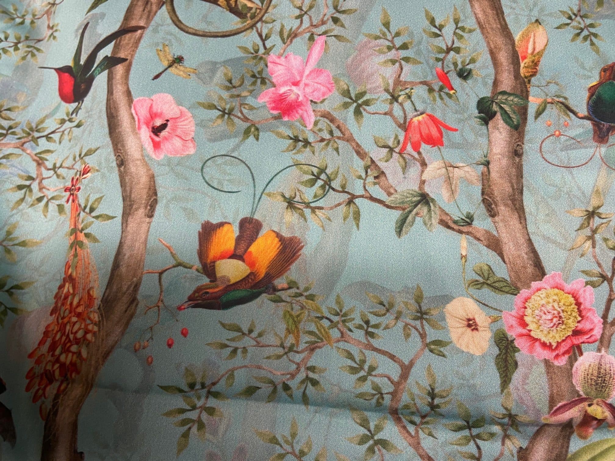 Fabric featuring hummingbirds and monkeys on a blue background, view 2