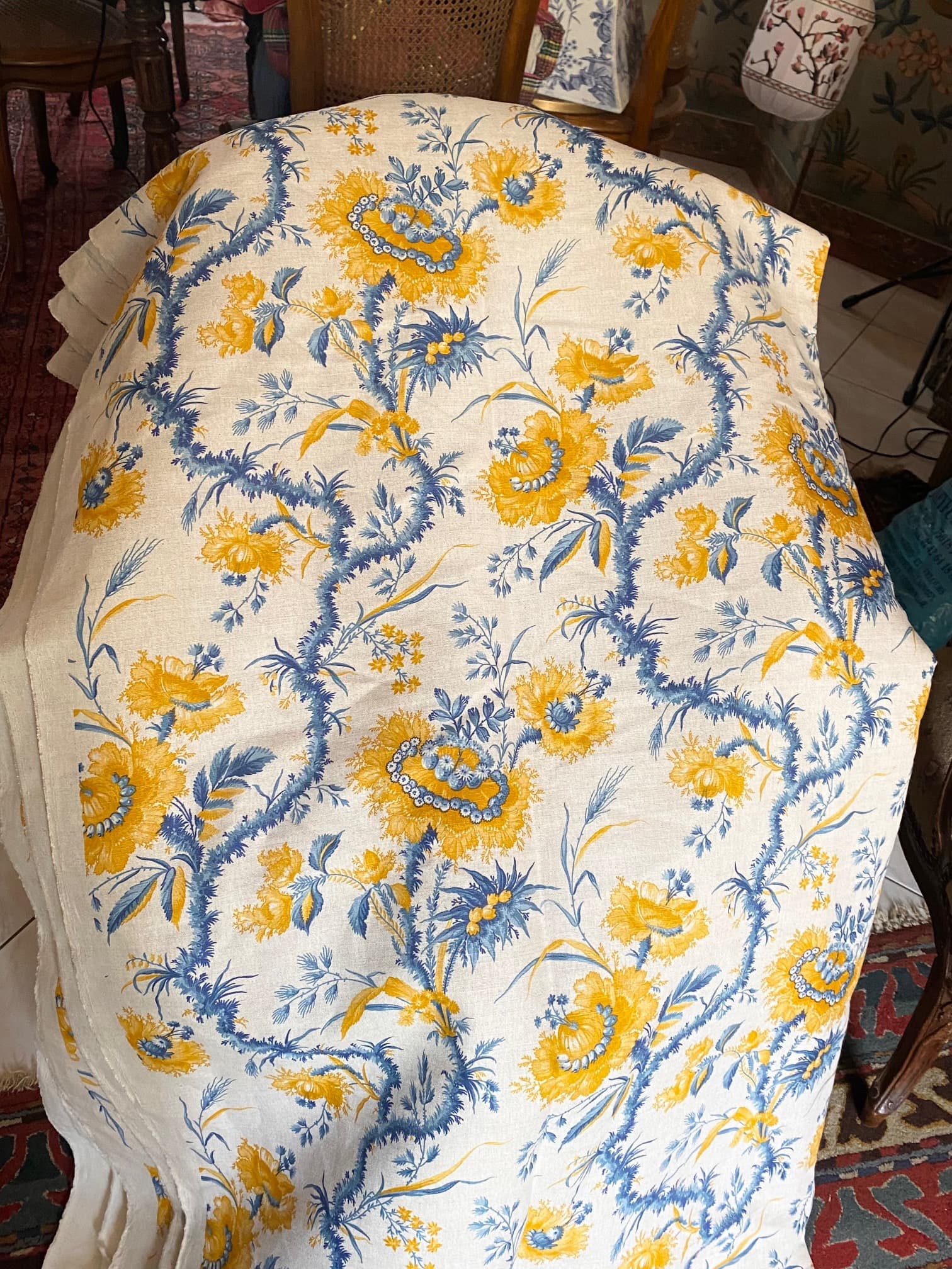 Fabric with large yellow and blue flowers, on a light linen background, view 2